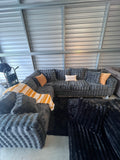 Waffle corduroy sectional in Grey, styled with pillows and throw