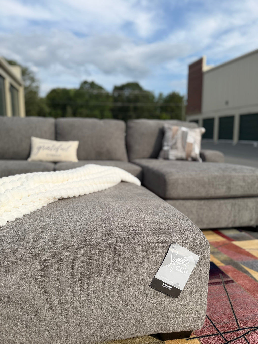 Ashley Newellen sectional, right chaise, ottoman detail