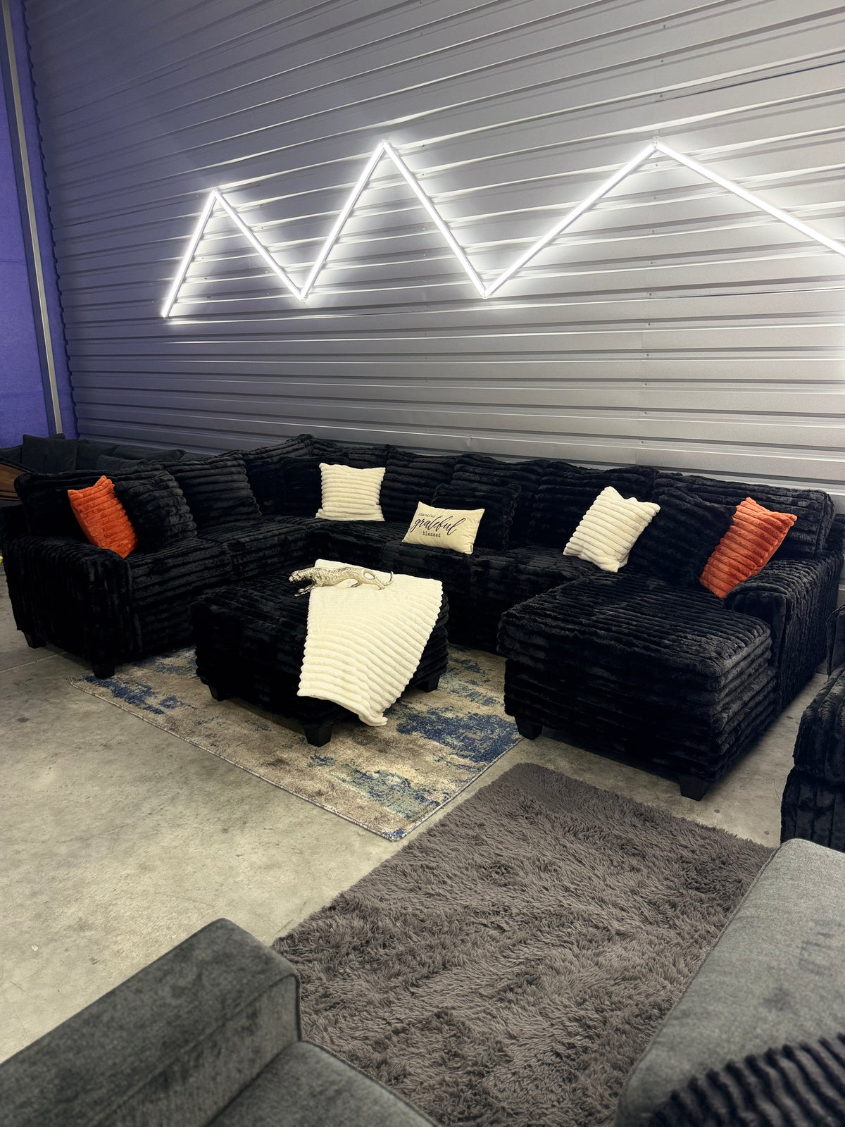 XL corduroy U-shape sectional in Black, showroom view