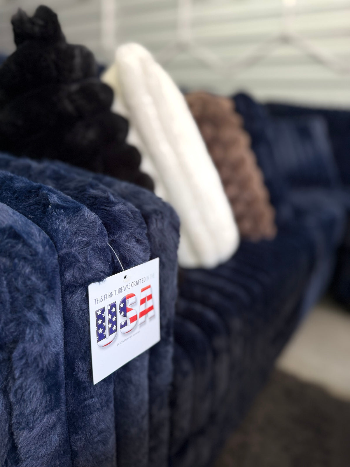 Navy plush sectional close-up with throw pillows
