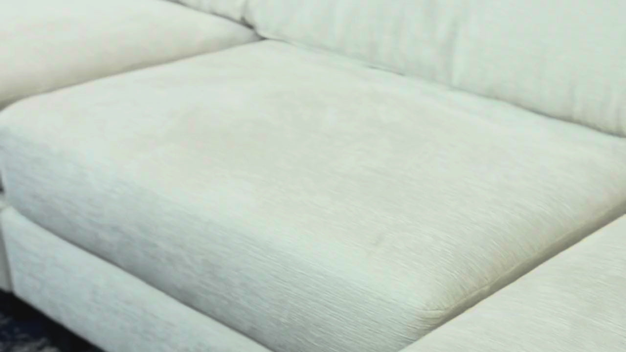 White sectional with orange pillow