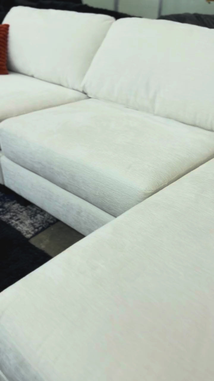 White sectional with orange pillow